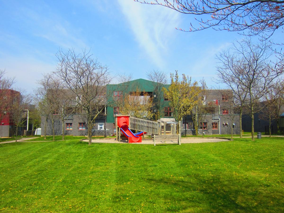 Picture of a playground in front of residence buildings at 78 College Ave.